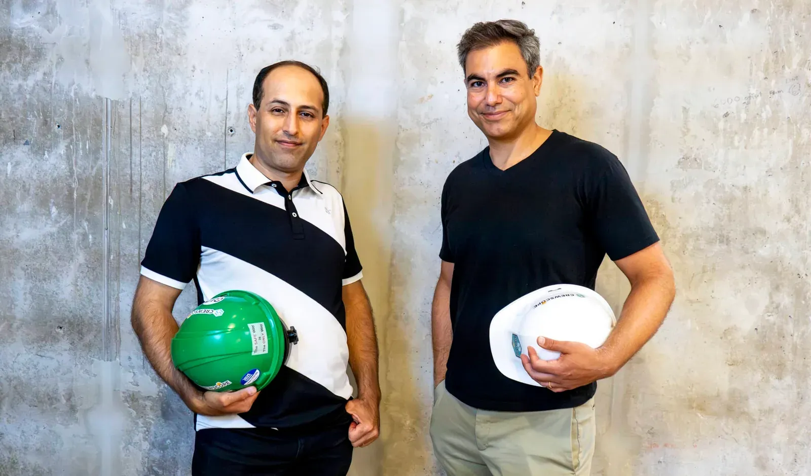 Crewscope co-founders Simon Thomas and Calvin Benchimol holding hard hats at head office