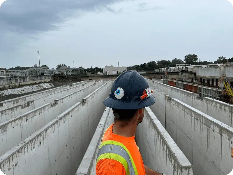 Maple Reinders site worker overlooking newly built concrete water treatment tanks