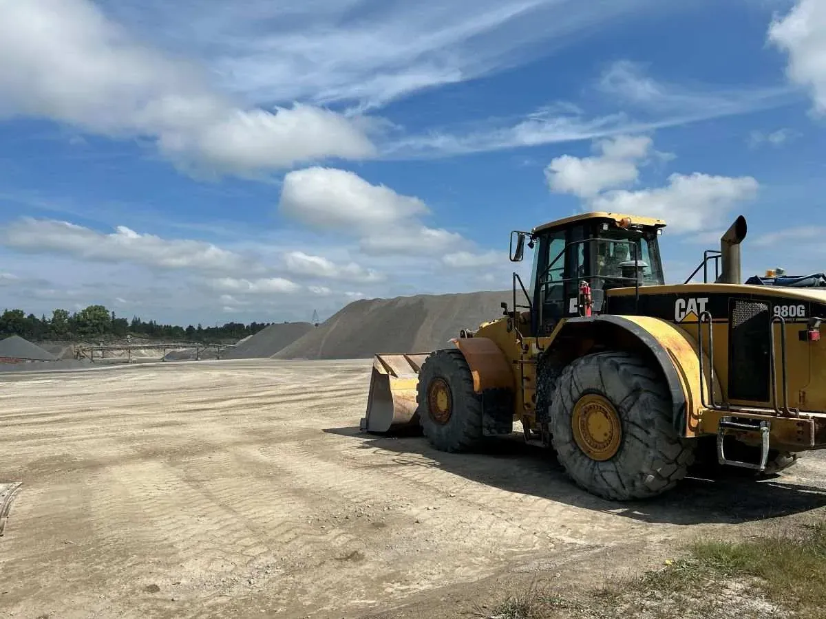 Caterpillar 980G wheel loader at Lafarge aggregate quarry on a clear summer day