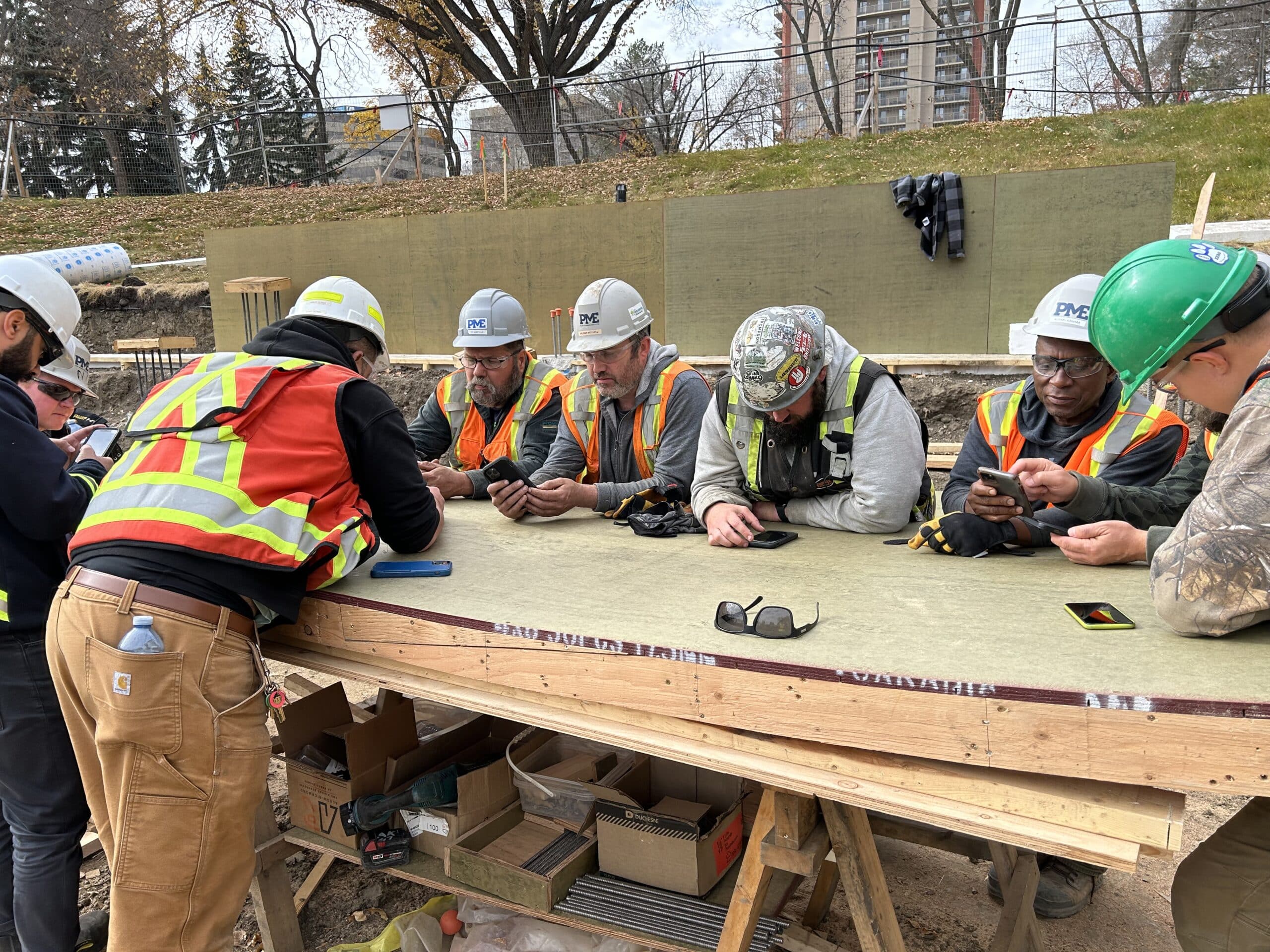 Crew of concrete carpenters unlock worker productivity by reviewing targets and progress with Crewscope at the Alberta Legislature in Edmonton.